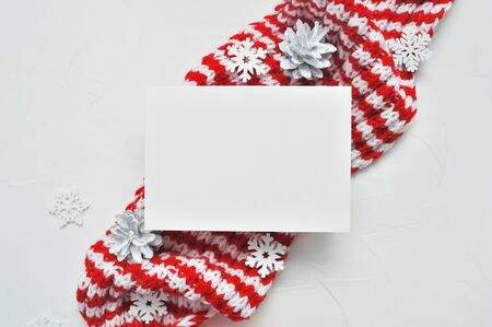 Letter mockup to Santa Claus with Santa red scarf on wooden background with place for your text. Christmas background with cones and snowflakesの写真素材