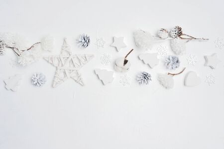 Border Design a Christmas greeting card with Xmas cones, heart, stars, cotton flowers with place for your text. Decorations on a white wooden backgroundの写真素材