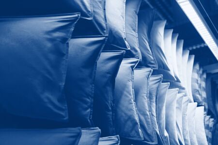 Classic blue tone pillows on shelves showcases. cushions in trendy 2020 year color