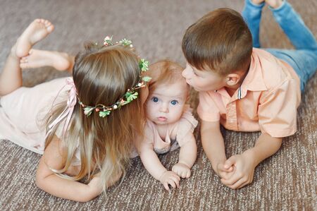 Little Children Together Hangout and Smiling in studio on floorの写真素材