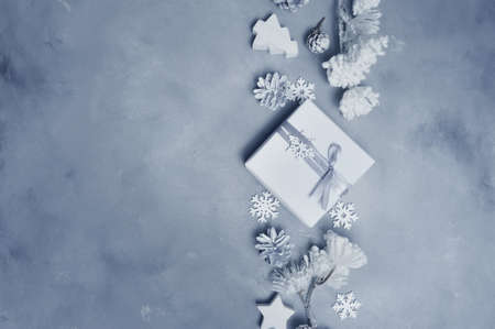 Mockup Christmas frame with cones, snowflake and wooden toys and gift boxes border over gray...