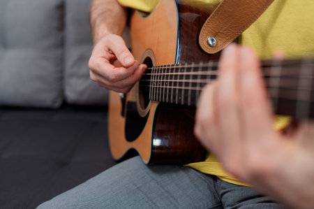 Guitarist on acoustic guitar playing melody. Close up musician instrumentの写真素材