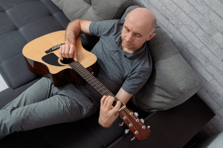 Guitarist on acoustic guitar playing melody in studio. Close up musician instrumentの写真素材