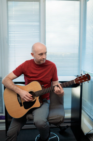Guitarist on acoustic guitar playing melody in studio. Close up musician instrumentの写真素材