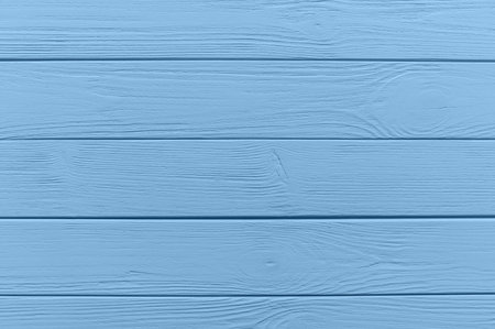 Horizontal wooden planks painted in light blue create a rustic and textured background, ideal for design projectsの写真素材
