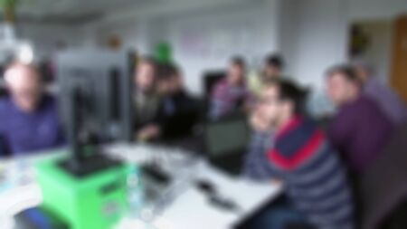 Cheerful business people in a meeting at office with blurry view.
