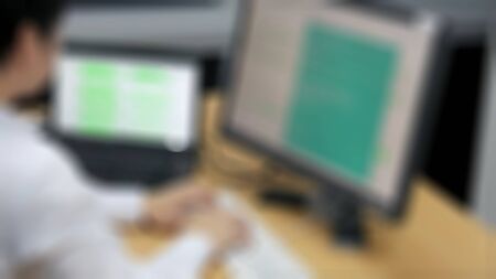 The system administrator works in the server room. The programmer makes a backup copy of the data center database on blurry view.の写真素材