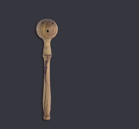 Top up view olive wooden olive spoon isolated on dark background. suitable for your design element.の写真素材