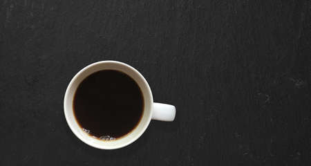 Top up view isolated hot black coffee isolated on dark table. added copy space for text.