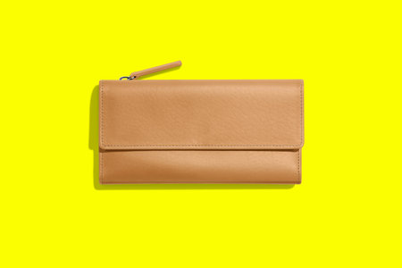 Fashionable leather women's wallet on a yellow background. added copy space for text.の写真素材