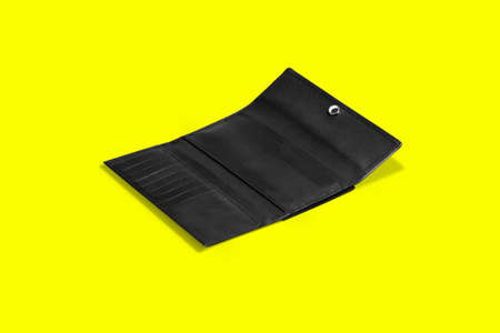 Fashionable leather women's wallet on a yellow background. added copy space for text.