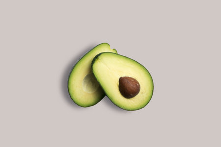 Fresh two slices avocado on a white background for the menu. Geometric background. Flat lay, copy...