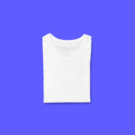 Top up up view white v neck t shirt folded isolated on blue background. suitable for your design project.の写真素材