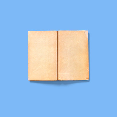 Soft book cover upside down open , isolated on blue background. vintage concept.の写真素材