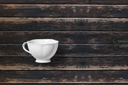 White tea cup top view over wooden background.