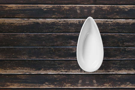 White sauce tray top view over wooden background.