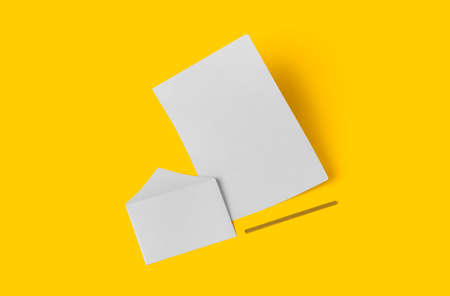 White empty stationery mock up, add your design . simple back to school concept isolated on yellow.の写真素材