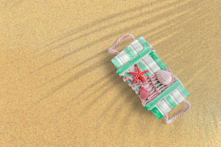 Top up view of green summer box on sand beach. vacation concept background.