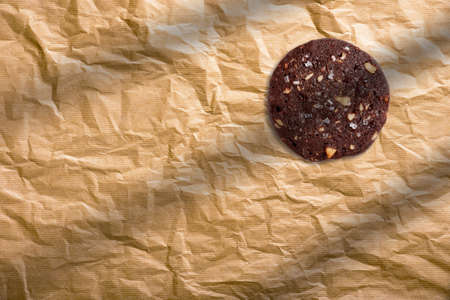 Double chocolate chip cookie on a brown paper, top view.の写真素材