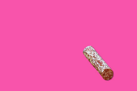 Piece of meat smoked bacon isolated on a pink background.
