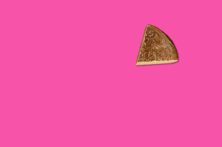 Cheese piece in Creative conceptual top view flat lay composition with copy space isolated on pink background in minimal styleの写真素材