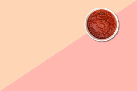 Close up view red tomatoes ketchup isolated on pink background.の写真素材