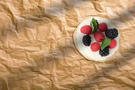 Fresh homemade pancake with strawberry and blueberry on baking paper. French bakery concept