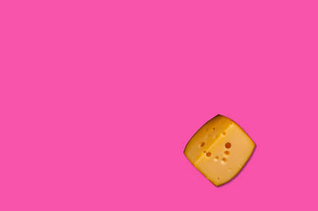 Cheese piece in Creative conceptual top view flat lay composition with copy space isolated on pink background in minimal styleの写真素材