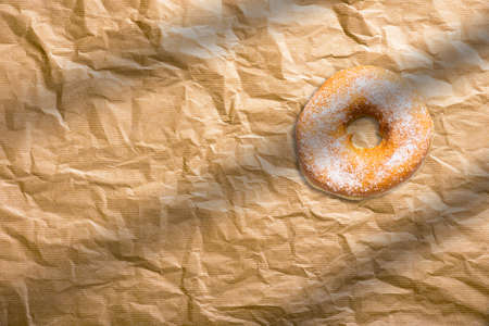 Fresh homemade donuts with sugar powder on baking paper. American bakery concept.の写真素材