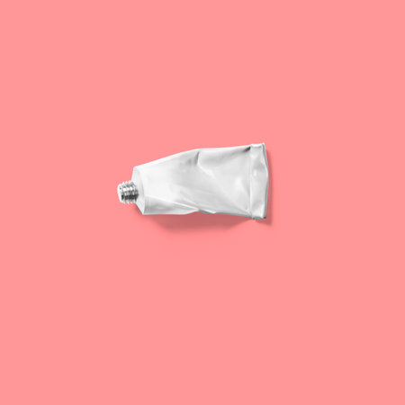 Top view of a white tube isolated on pink background.の写真素材