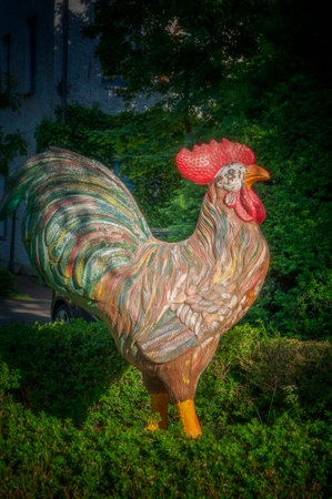 BUNDE, GERMANY. JUNE 12, 2021. Beautiful view of small german town. Small statue of cock on the yard.のeditorial素材