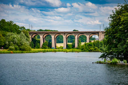 BIELEFELD, GERMANY. JUNE 20, 2021. Loheide park. Lake view to the big railway bridge.の写真素材