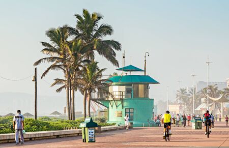 DURBAN, SOUTH AFRICA - APRIL 16, 2016: Locals and tourists near the lifesaver's station on The Golden Mile promenadeのeditorial素材
