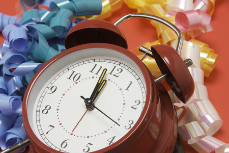 Red Alarm clock and ribbon for holiday occasions.の写真素材