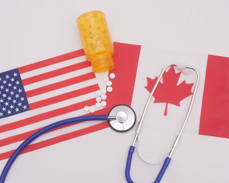 Current healthcare available  in Canada vs USA with a stethoscope and prescriptionの写真素材