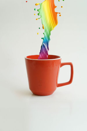 Rainbow color swirl flowing into a red cup symbolizing creativityの素材