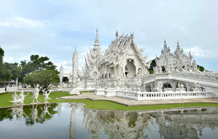 The famous White temple at Chiang Rai, Thailand, or Wat Rong Khun in Thai. White temple with its authentic Buddhist ornaments and engraving covered in all white paint.の写真素材