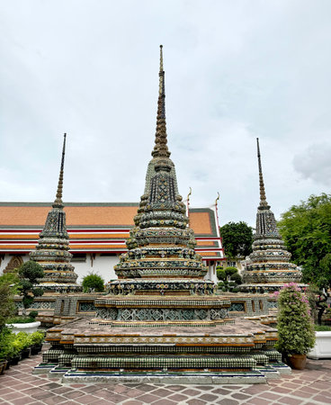 Series of pagoda and chedi made of crafted and sculpted stone, painted in many colors and made of decorative ornaments. Wat Pho pagoda complex, Bangkok , Thailand.の写真素材