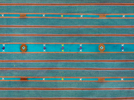 Traditional ethnic fabric in random horizontal linear line pattern, ethnic cloth dyed in blue and...