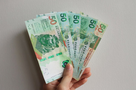 Portrait of a collection of Hongkong Dollars (HKD) at the nominal of $50, isolated on a white wall background.の写真素材