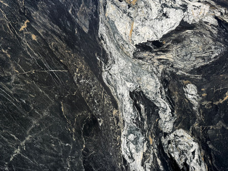 Natural black and white marble slab pattern in rough textured finishes, Fusion Black Panda marble with white veinings, rough stone texture. Seamless pattern.の写真素材