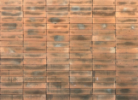 Red orange brickwall texture on an exposed wall with cement and natural contour.