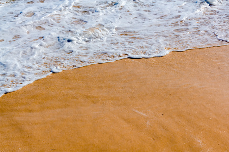 Close up photo of calm waves from an ocean in a beach in summer.の写真素材