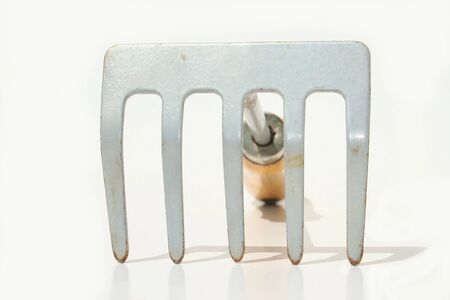 Hand rake against white backgroundの写真素材
