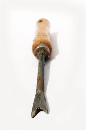 Small weeding fork against white background