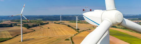 Banner aerial view and close-up of a wind turbine