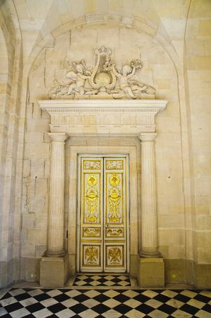 Fancy gold door with black and white marbled tile floorの写真素材