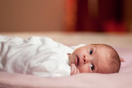 awake little newborn in the room  の写真素材