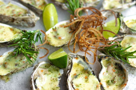 Seafood background. Oysters baked with cheese on plate. Mediterranean cuisine with seafood. Food...