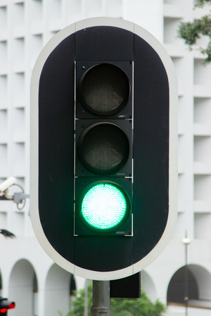 Green traffic light on city highway road close up. Traffic light on urban street.の写真素材